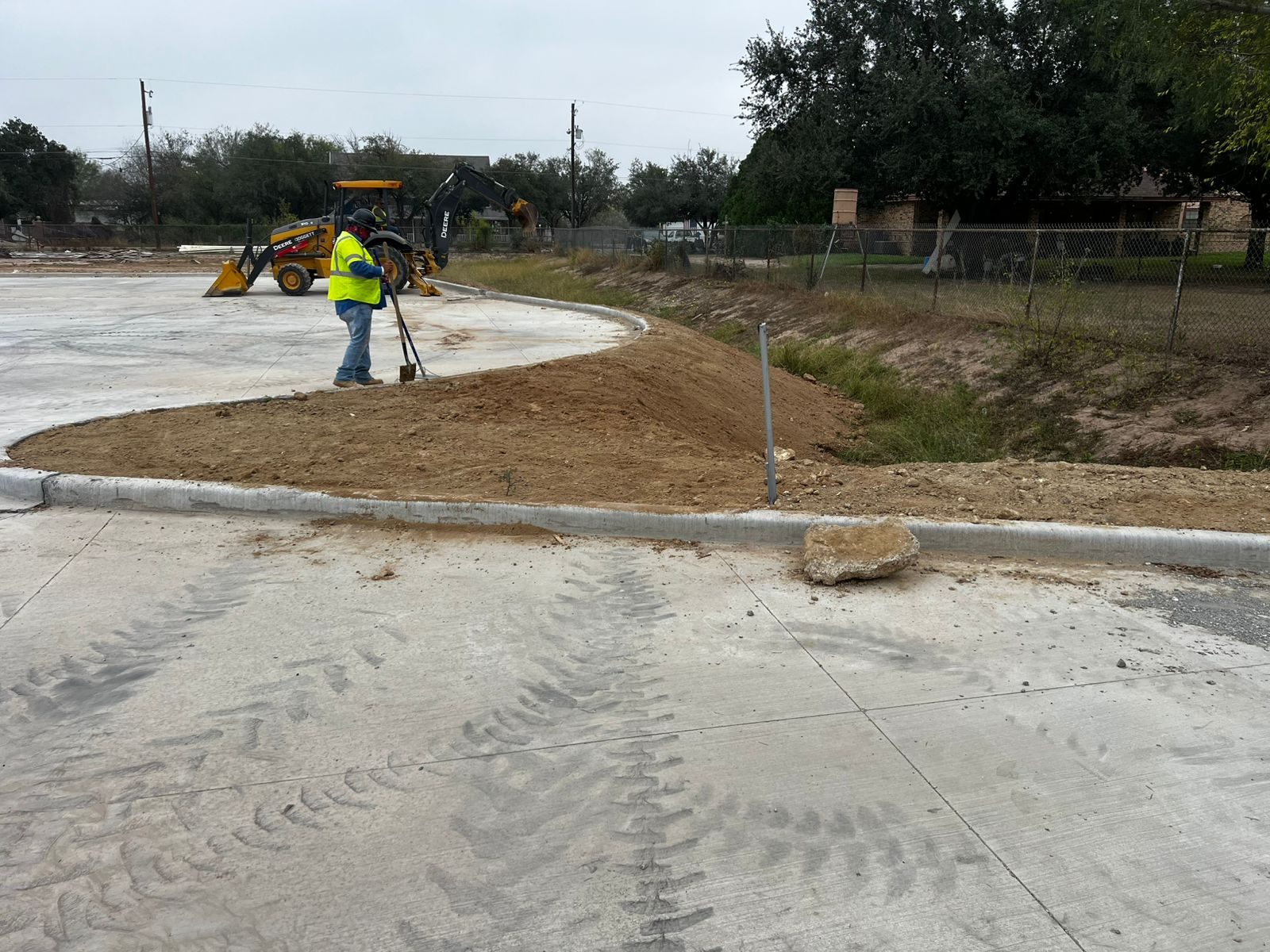 Finished grading around concrete pavement